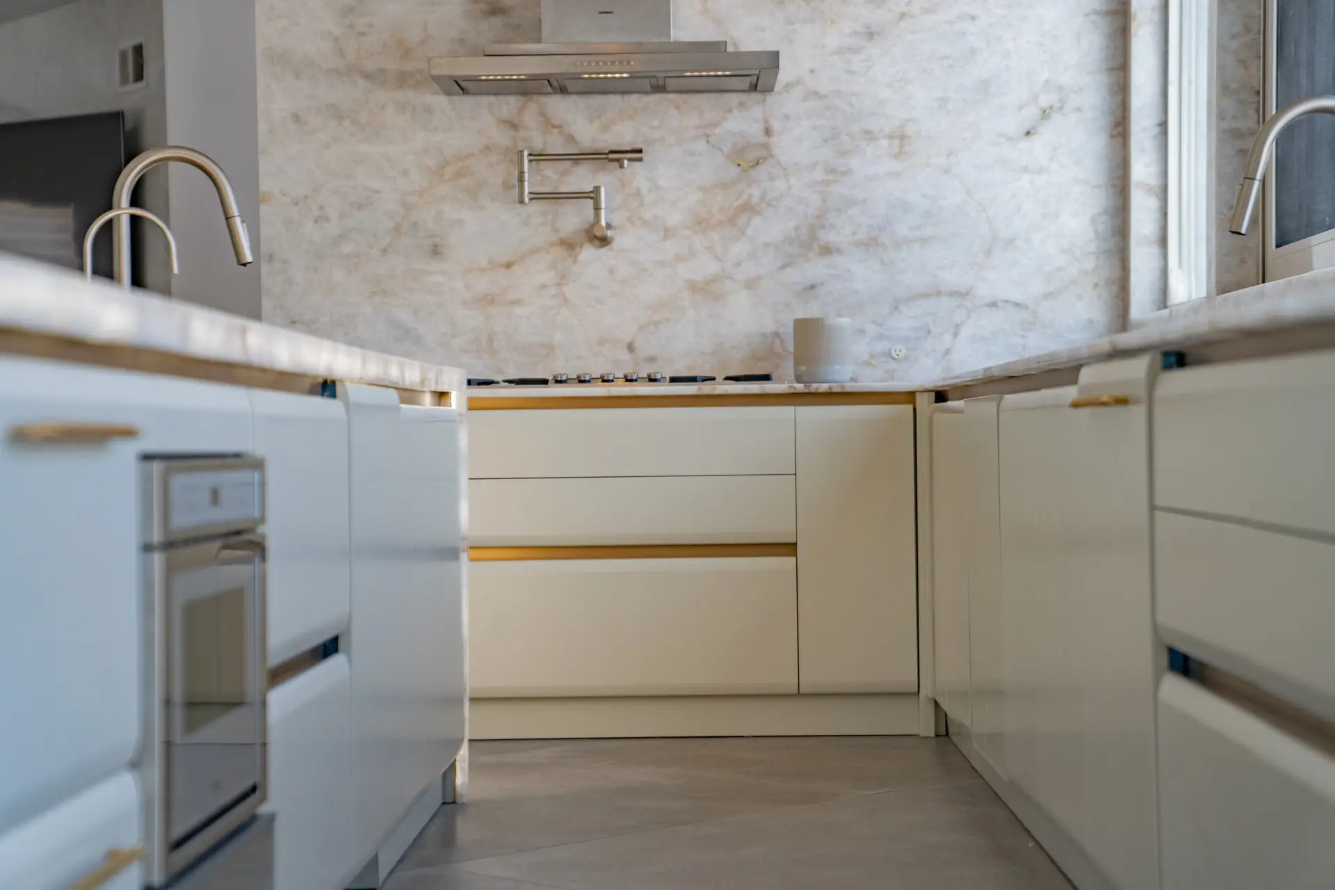 Luxury kitchen faucet detail with premium countertop and custom cabinetry